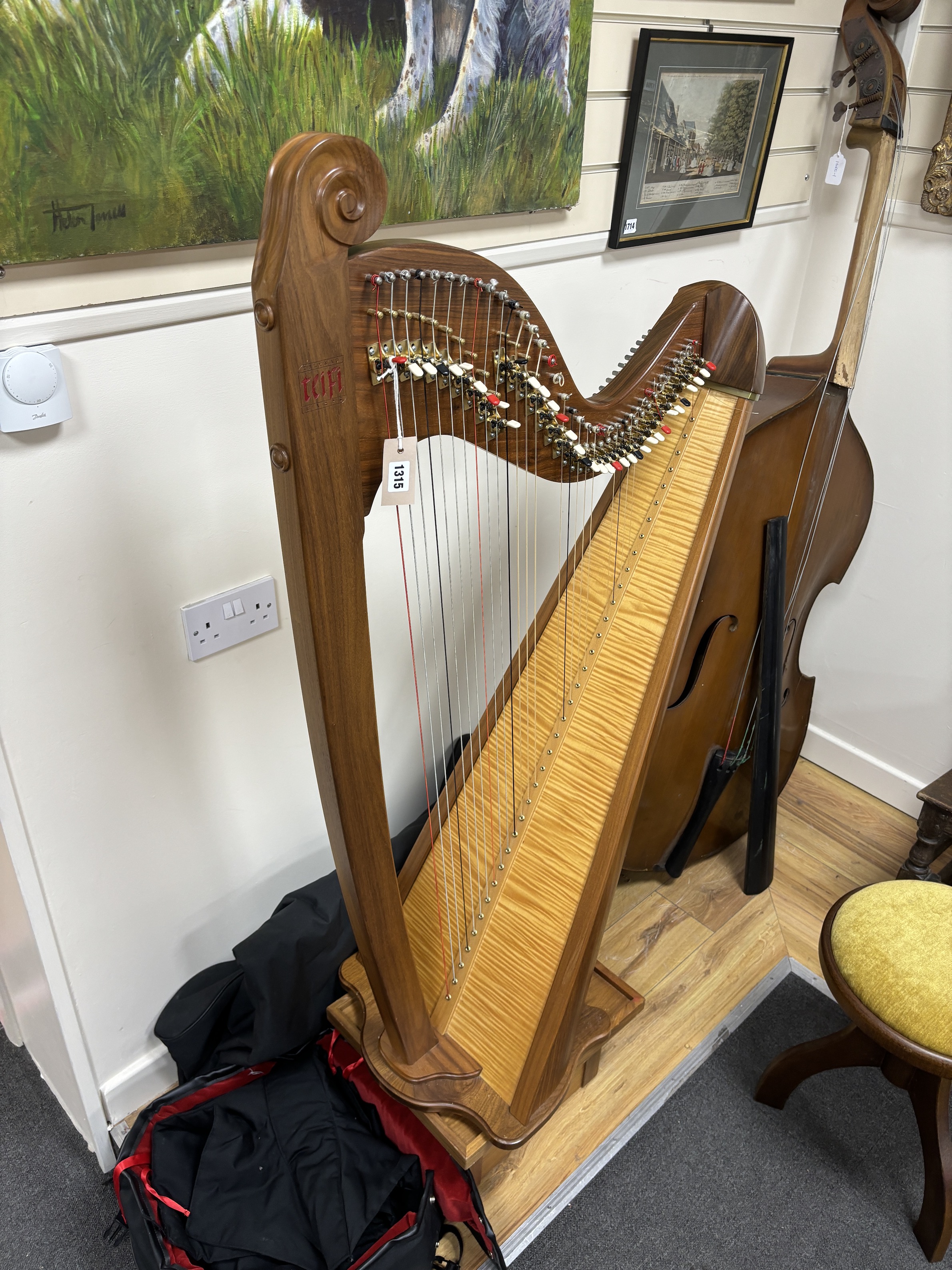 A modern Welsh Teifi Telynau harp, 36 string harp with maple sound board, carved maker’s mark, stool, stand and tuner, with substantial padded cover and transport case, 130cm high